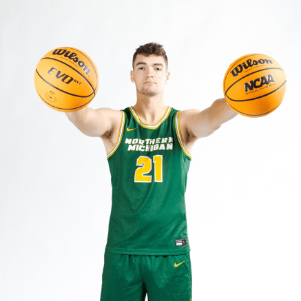 male basketball player holding two basketballs