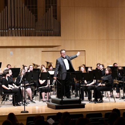 Dr. Steve Grugin stands in front of one of the NMU concert bands