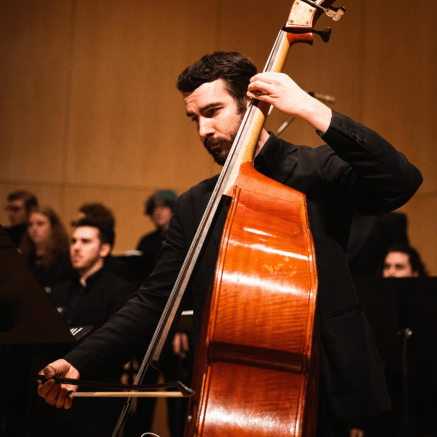 man playing a stand up bass